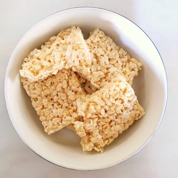 Instant rice krispies treats - Top down view of homemade marshmallow rice krispie treats in a bowl on a white background