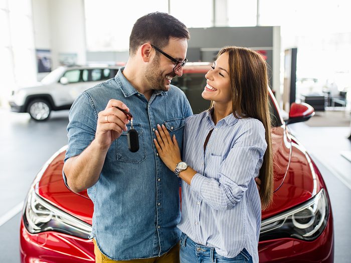 Best time to buy a car in Canada - young couple at car dealership