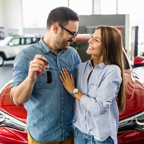 Best time to buy a car in Canada - young couple at car dealership
