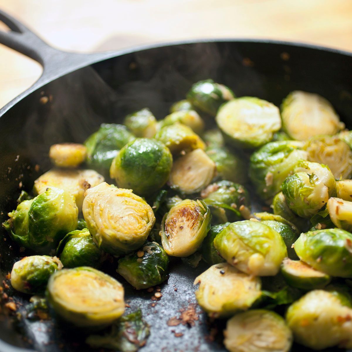 brussels sprouts hot off the stove with steam rising from the pan