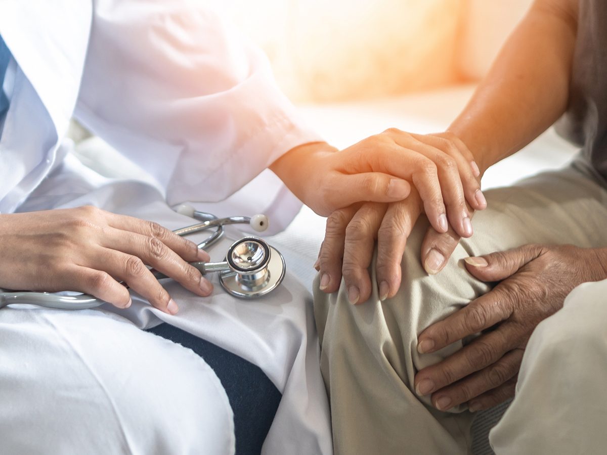 Doctor comforting patient with Parkinsons disease