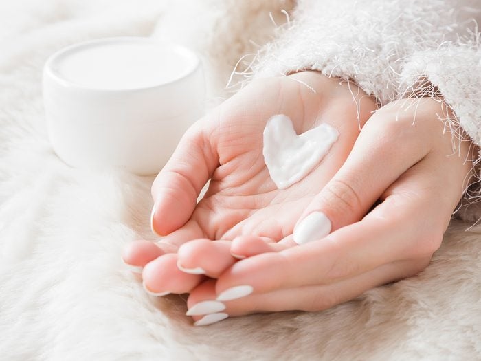 Dry skin in winter - woman with moisturizer in hands