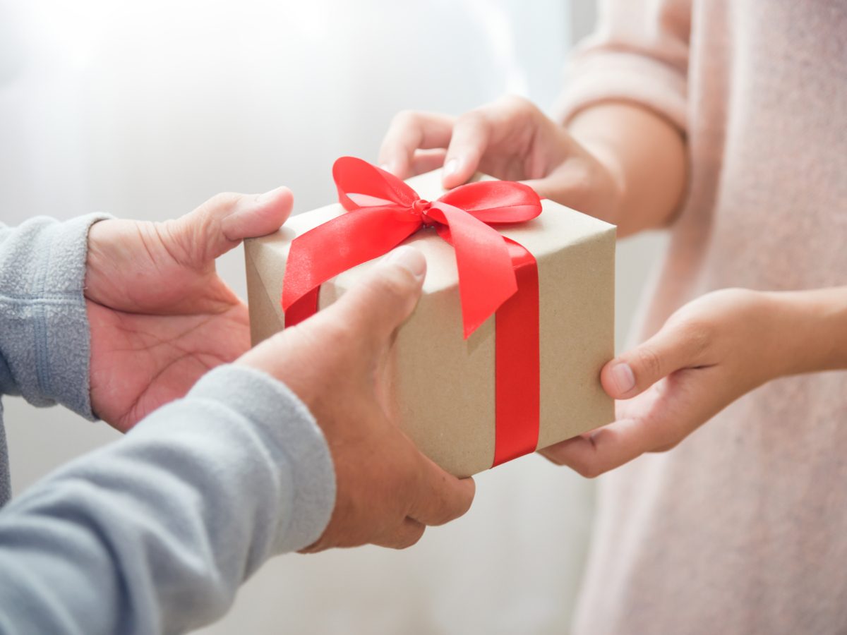 Close-up of hands exchanging gifts