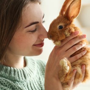 Young woman with pet bunny