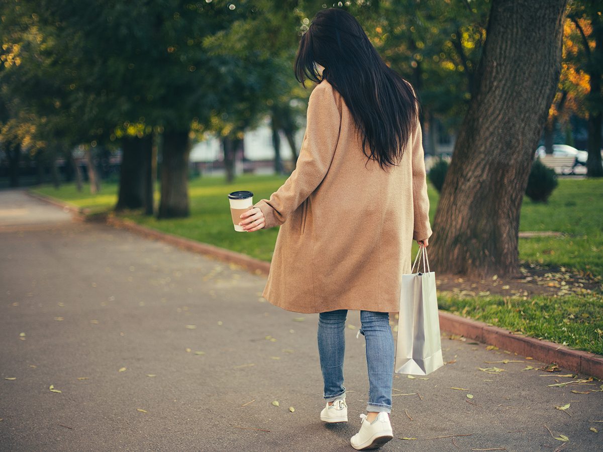 Walking mistakes - Woman walking with bag and coffee