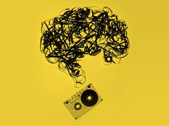 vintage cassette tape with the tape pulled out and formed into the shape of a brain