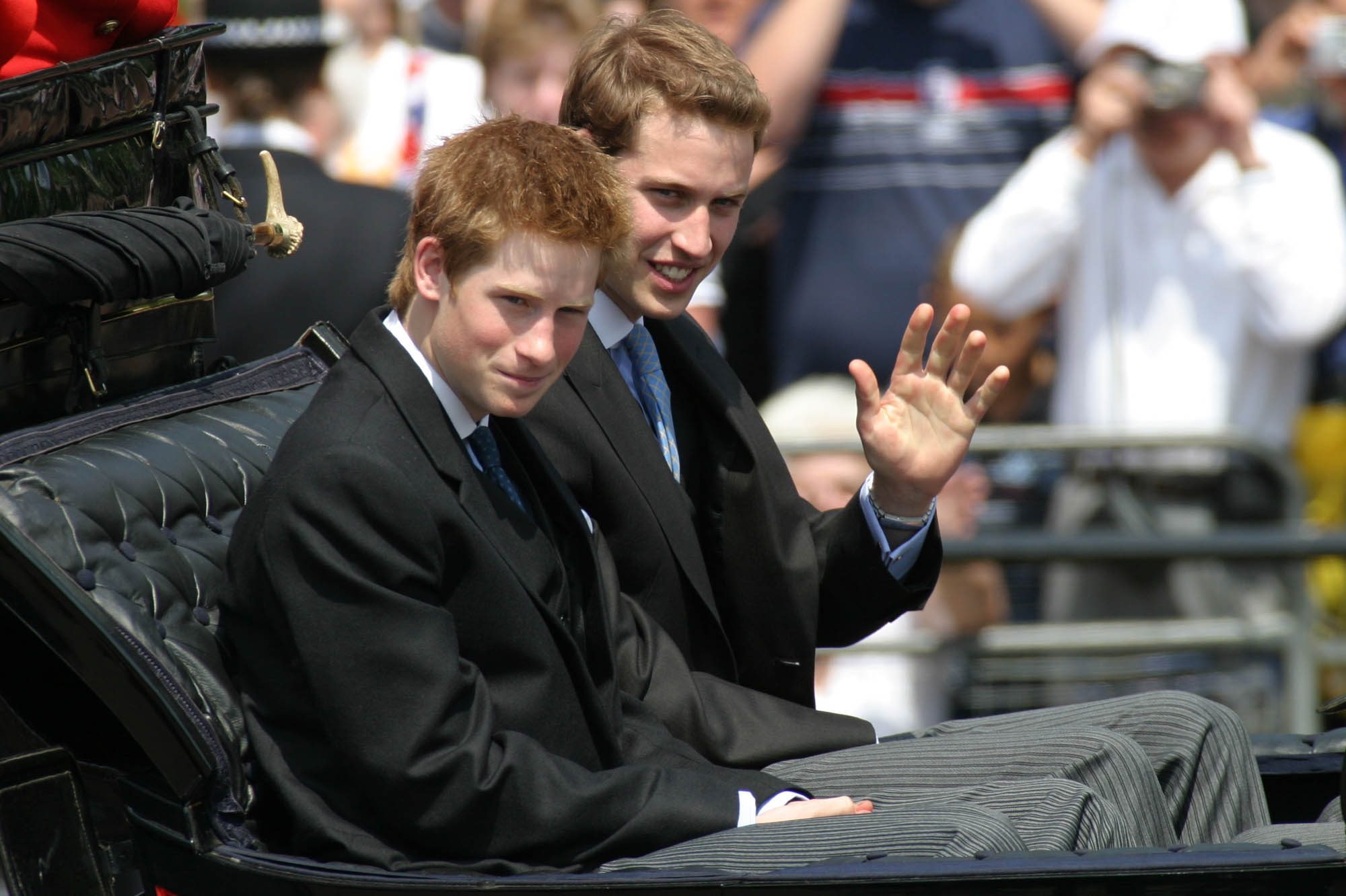 Prince Harry, left, and Prince William in a carriage return to Buckingham Palace from Horse Guards Parade