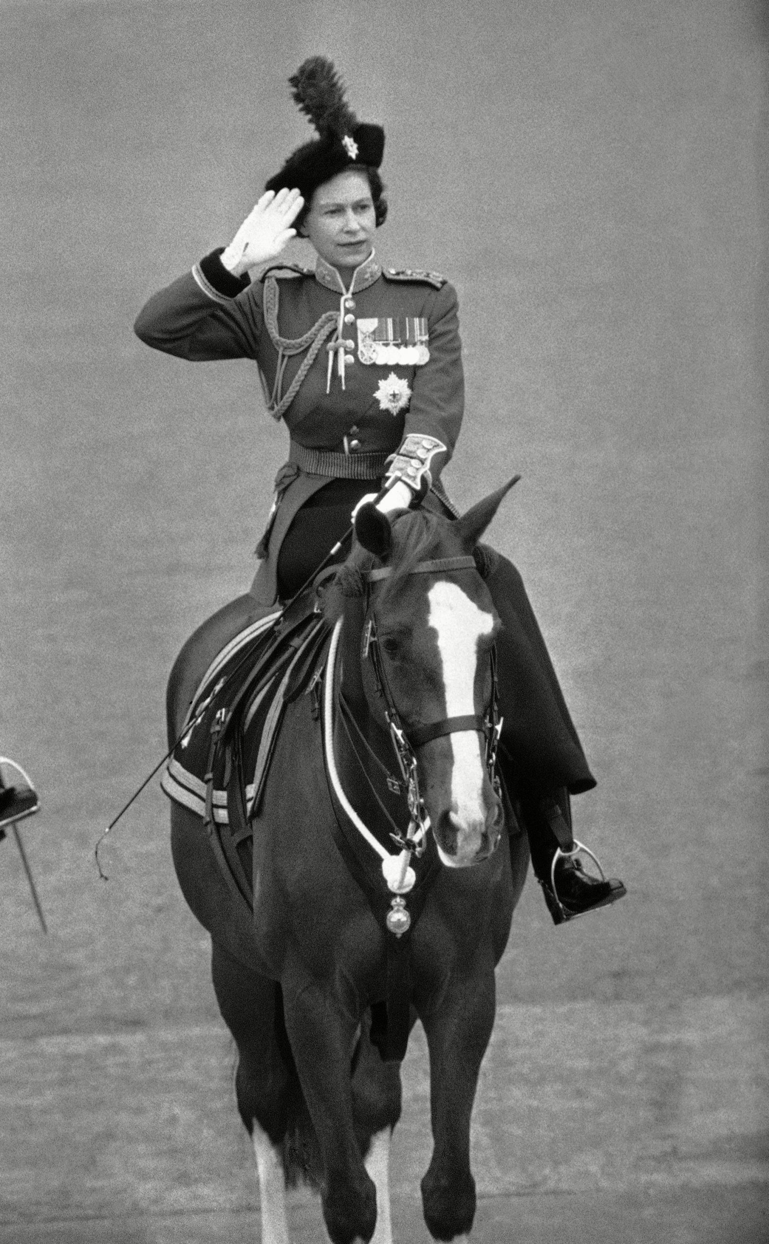 Queen Elizabeth II takes the salute at the traditional Trooping the Color