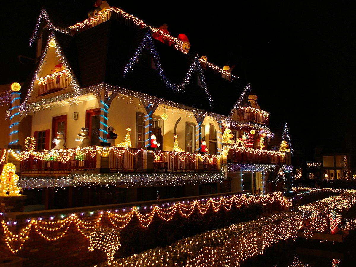 Guide to Christmas lights - Home with lights reflected in the water