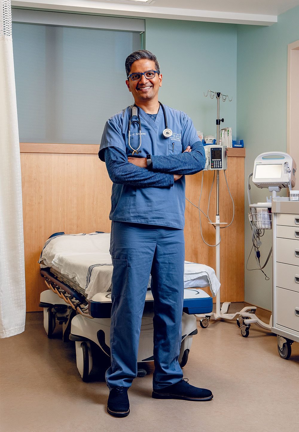 Dr. Kris Srivatsa standing in a hospital room.