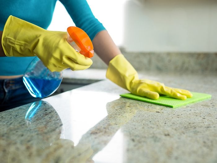 Woman cleaning countertop