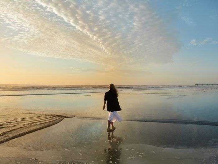 New Year's resolutions - woman walking on beach