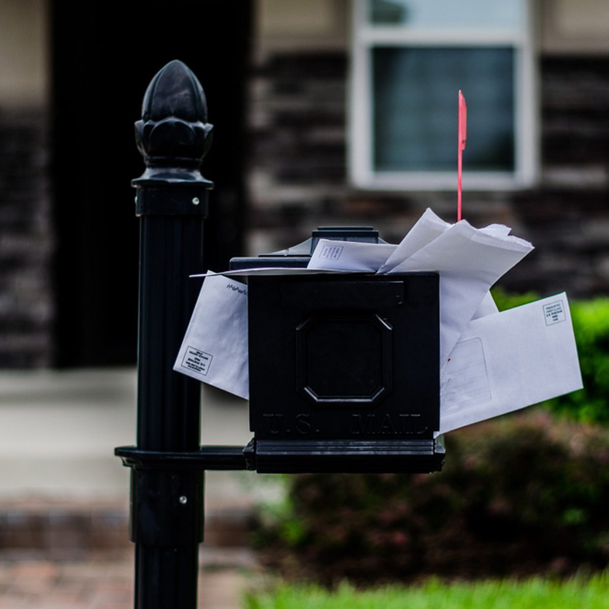 An overflowing mailbox reads like an invitation to burglarize.