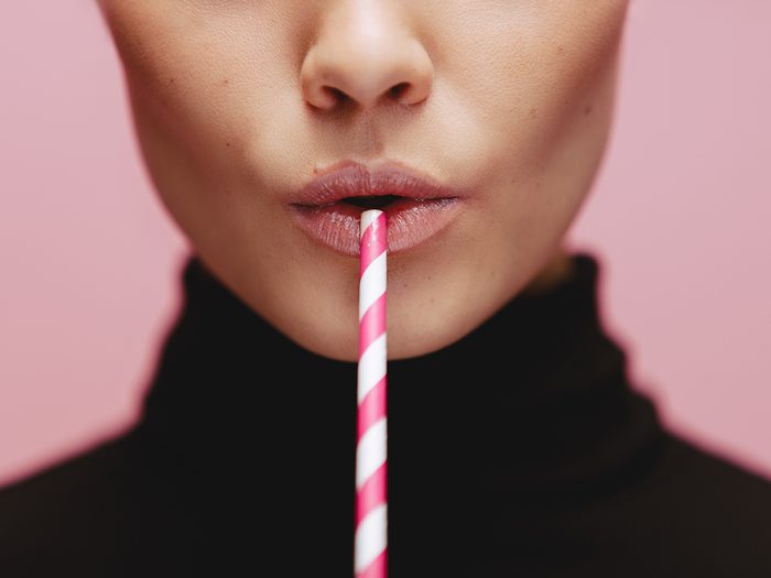 Woman drinking with straw