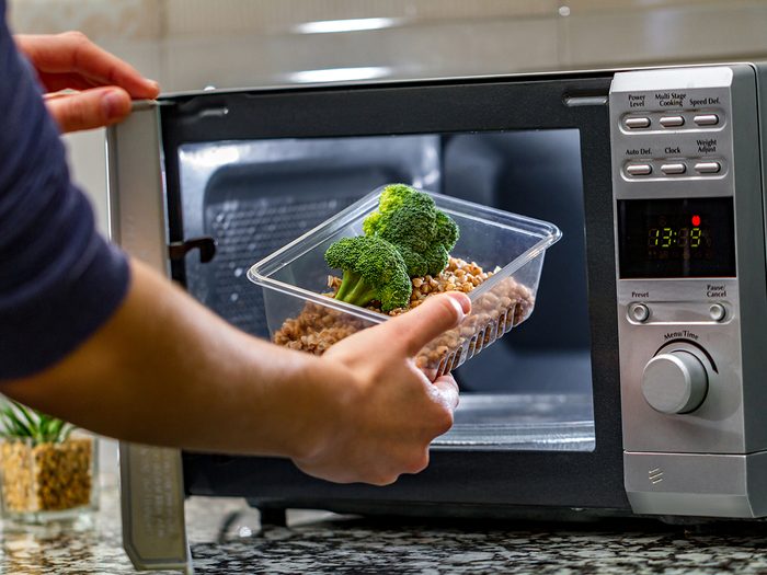 Man cooking dinner in microwave