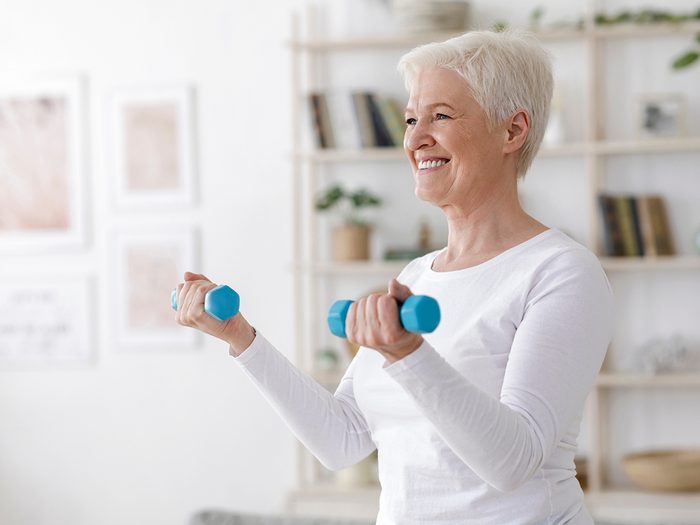 Mature woman lifting weights - aging well