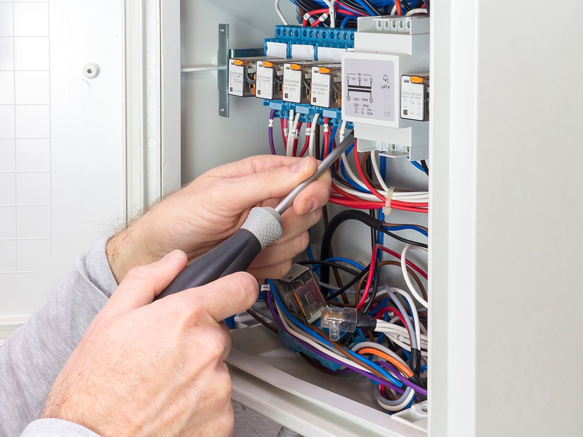 electrician at work on an electrical panel
