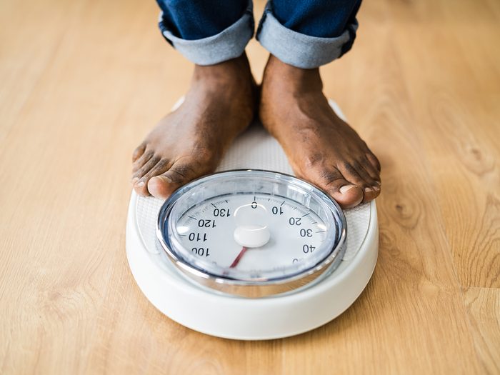 Signs of diabetes - man weighing on scale
