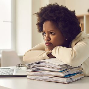 Signs you need to move more - sluggish woman at desk