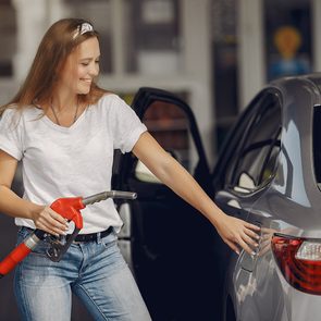 Bad Gas Pump Habits - Woman Refueling Car