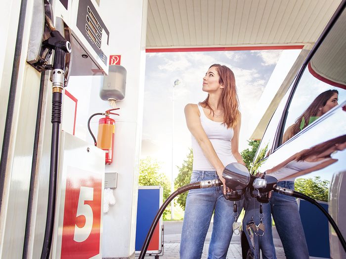 Car myths - woman filling up car with premium gas