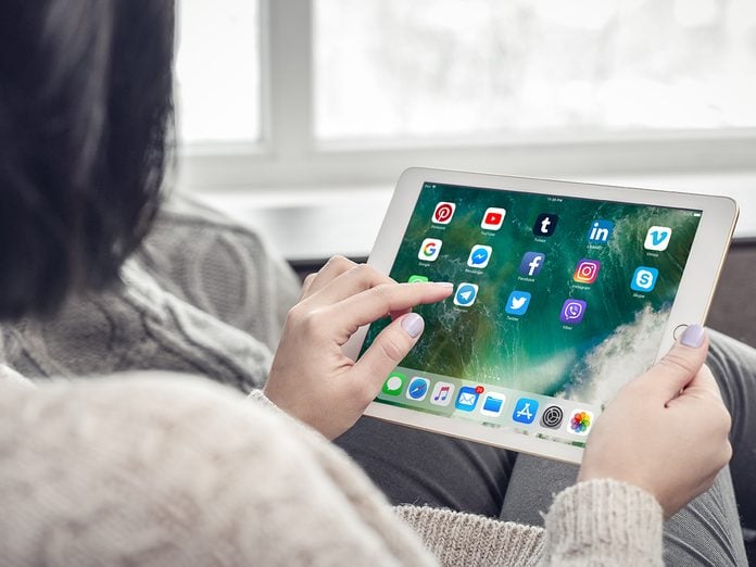 Woman using social media apps on a brand new Apple iPad Pro