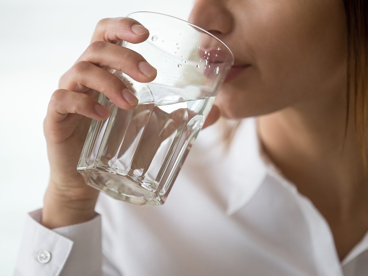 Drinking eight glasses of water a day - woman drinking water