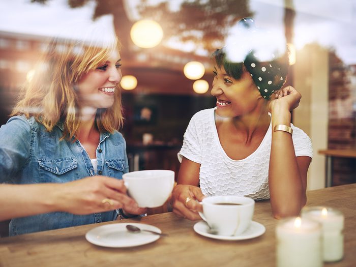 How to be a more compassionate person - two girl friends at a coffee shop