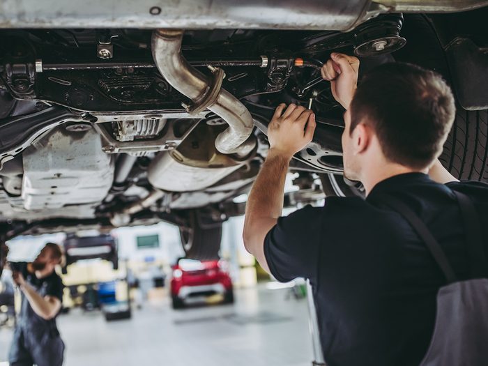 Mechanic secrets - mechanics working under car on lift