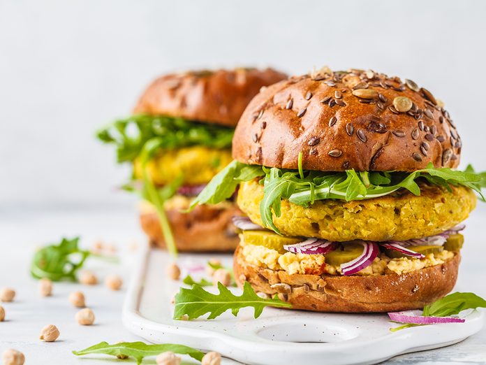 Plant based foods Canada - Vegan chickpeas burgers with arugula, pickled cucumbers and hummus. Plant based diet concept