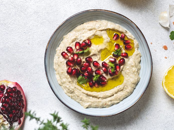 Plant based foods Canada - Levantine appetizer Baba ghanoush baked eggplant appetizer served with pomegranate seeds, top view