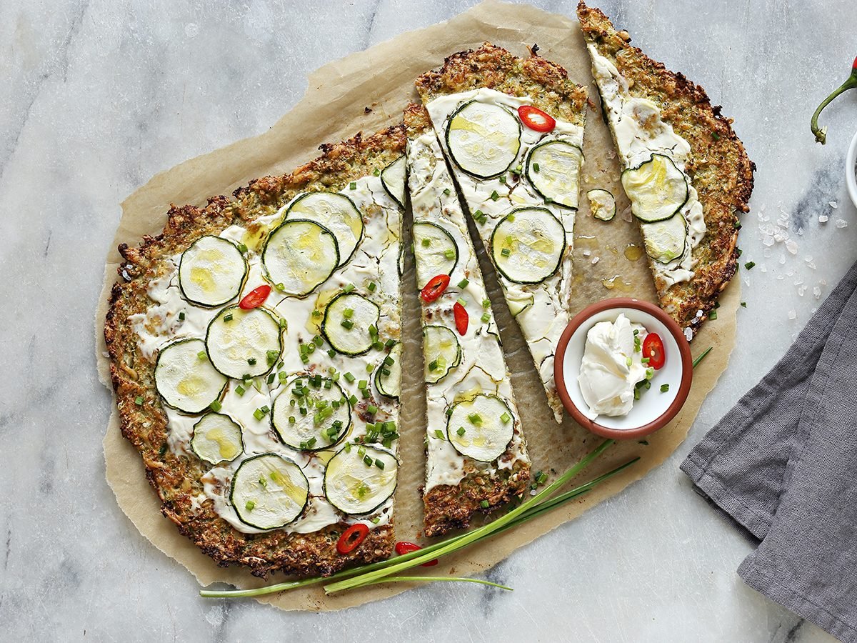 Cauliflower Pizza Crust With zucchini, cream cheese and spring onion . Vegetarian, nut free, grain free, low carb. Gluten free recipe for low carb, plant based,clean eating diets concepts.