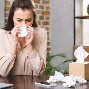 adult onset allergies - Woman Sneezing