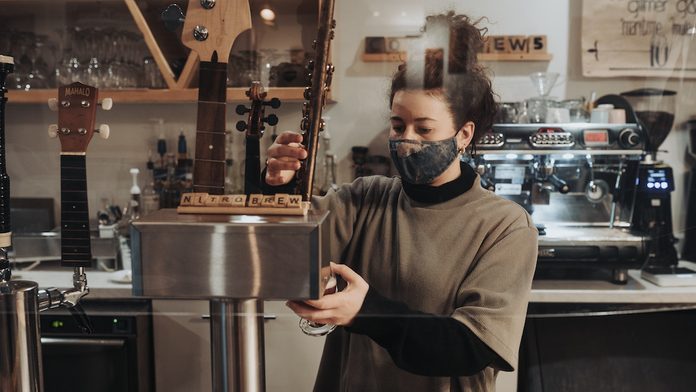 A barista makes a coffee drink at Tipsy Muse Cafe