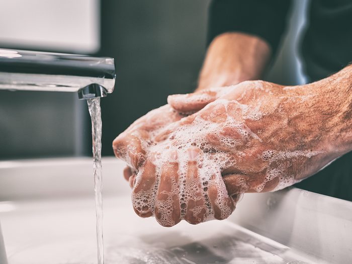 Bar soap vs. liquid soap - man washing hands