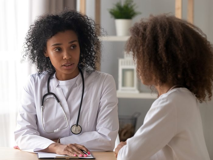 Doctor having serious discussion with female patient