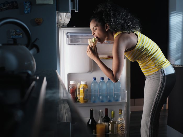 Foods nutritionists never eat late at night - woman eating out of fridge
