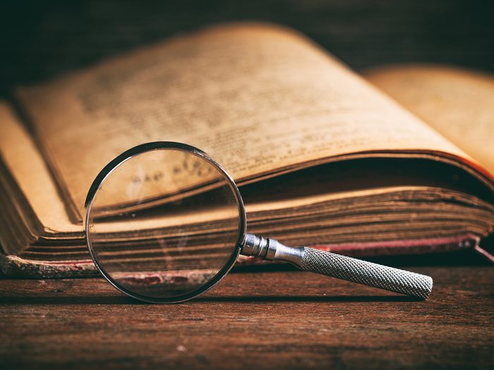History questions - dusty old history book with magnifying glass