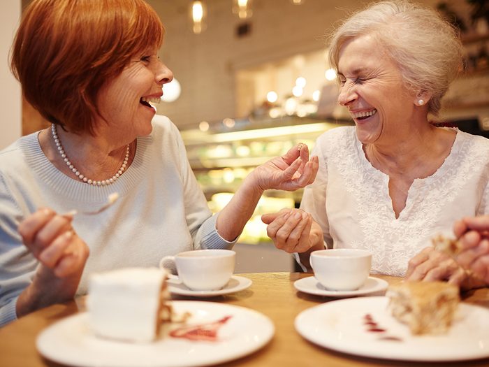 How to live to 100 - two mature women at cafe laughing