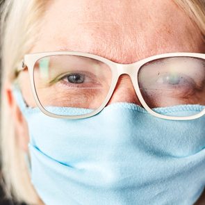 How to stop glasses from fogging up - blond woman in foggy glasses and antiviral mask