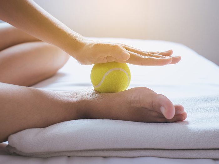 Foot pain relief - tennis ball on foot