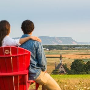 Historical landmarks Canada - Visitors with red chairs at the Landscape of Grand-Pré View Park. A UNESCO World Heritage Site. Grand-Pré National Historic Site.
