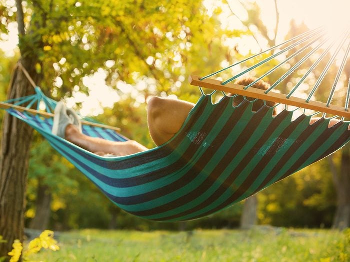 Best Canada hammocks - person lying in backyard hammock