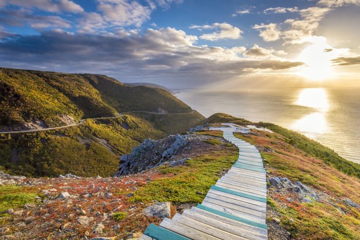 Best place to watch the sunset in every province - A view of the sun setting over the Atlantic ocean from the top of the Skyline Trail in Cape Breton Highlands National Park National Park.