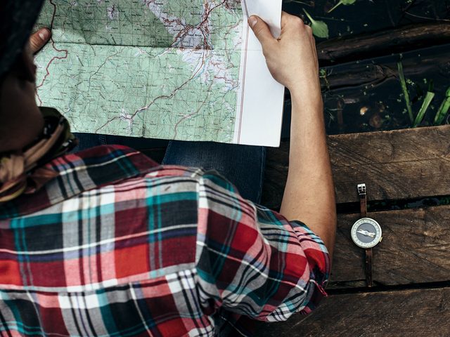 Hiking for beginners - Hiker planning route on map