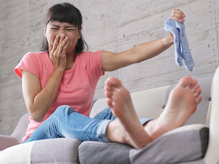 Home remedies for stinky feet - woman with smelly foot odour