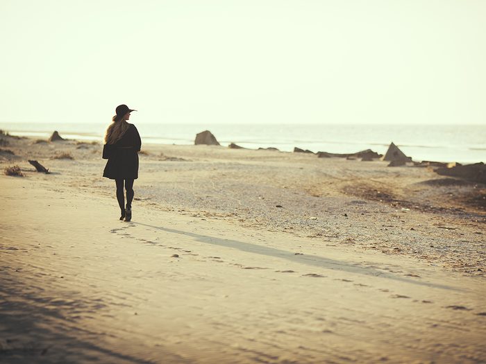 How to be brave - woman walking alone on beach