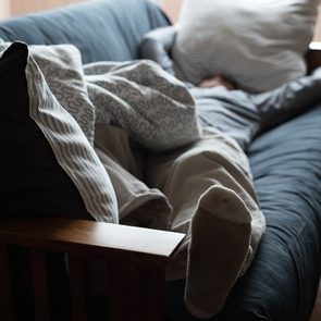 Man napping on sofa - sabotaging sleep