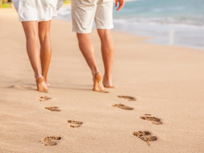Baby terms - couple walking on beach barefoot