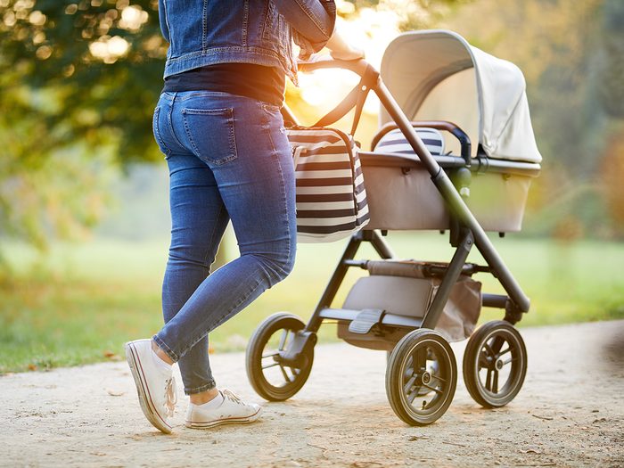 Baby terms - woman pushing stroller in park